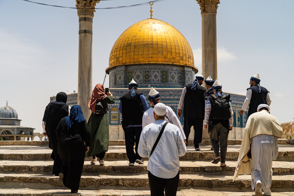 a group of people walking up some steps