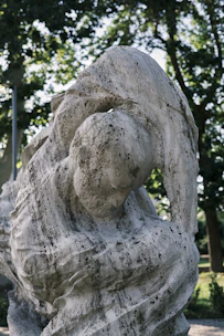 Close-up of a smooth, polished serpentine stone sculpture with intricate African patterns.