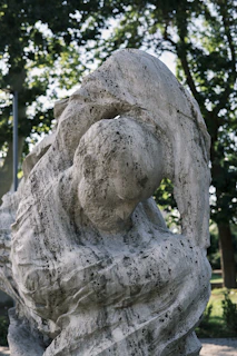 Close-up of a smooth, polished serpentine stone sculpture with intricate African patterns.