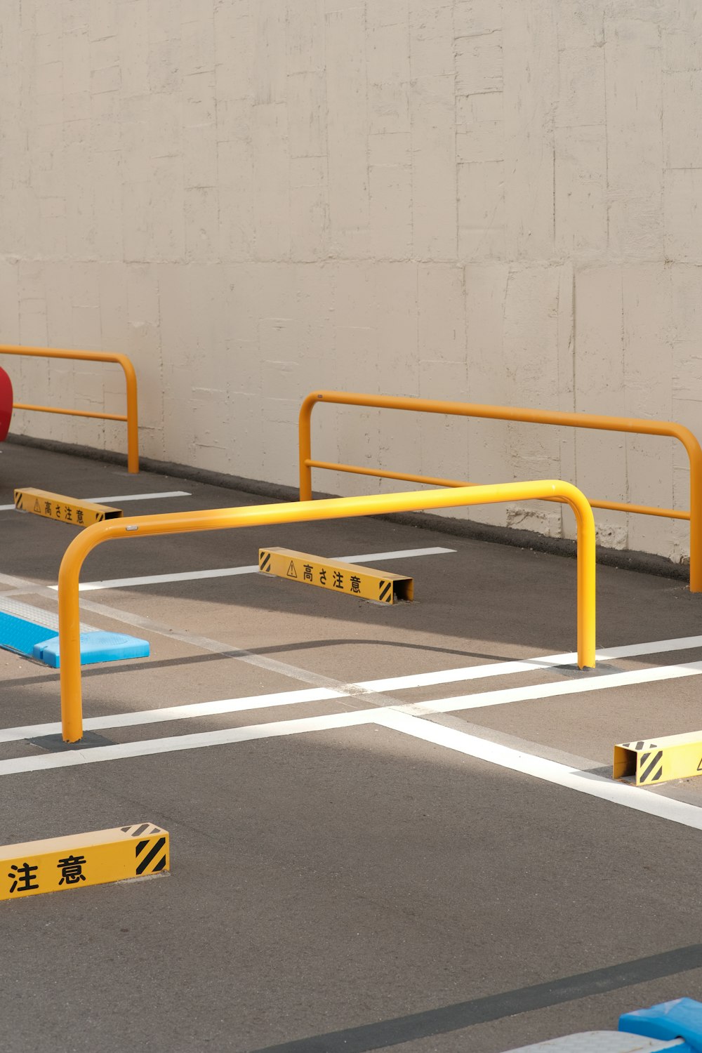 a parking lot with yellow and blue barriers
