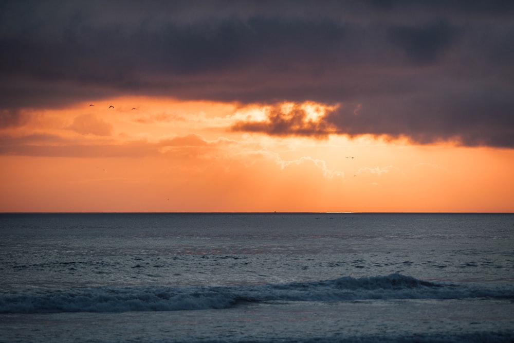 a large body of water under a cloudy sky