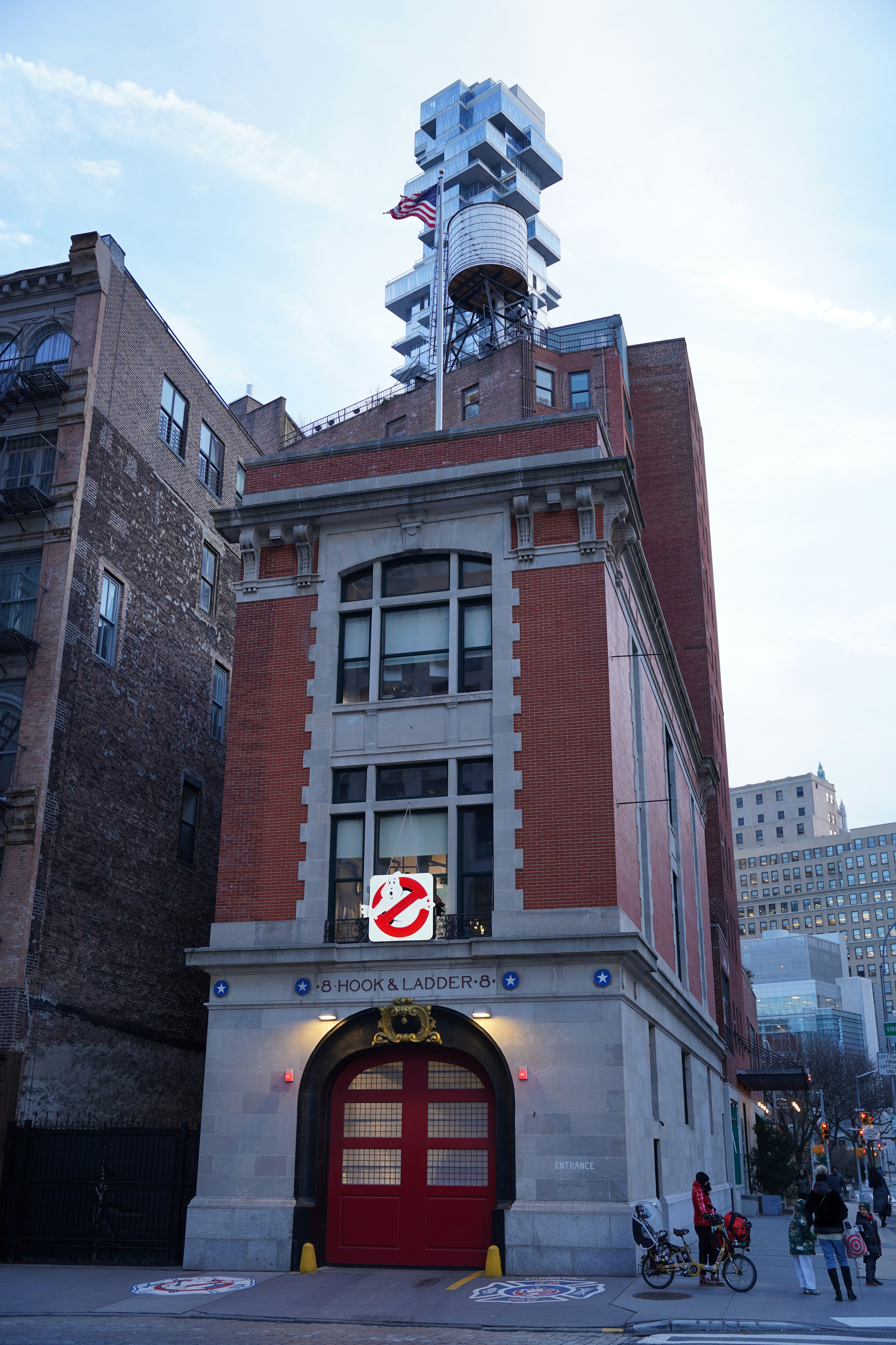 a tall building with a red door and a red fire hydrant