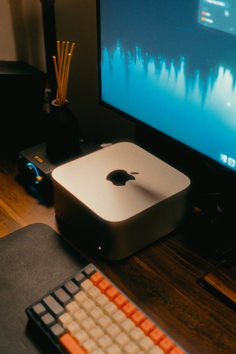 an apple computer sitting on top of a wooden desk