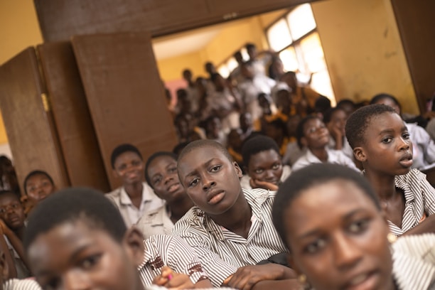 a group of young people sitting next to each other