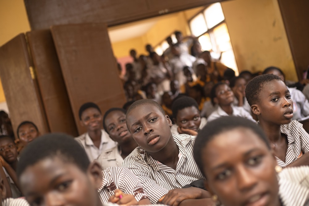 a group of young people sitting next to each other