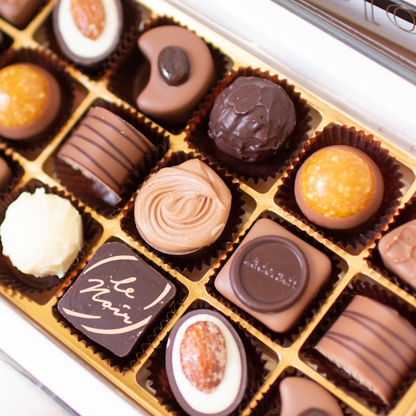 a box of assorted chocolates sitting on a table