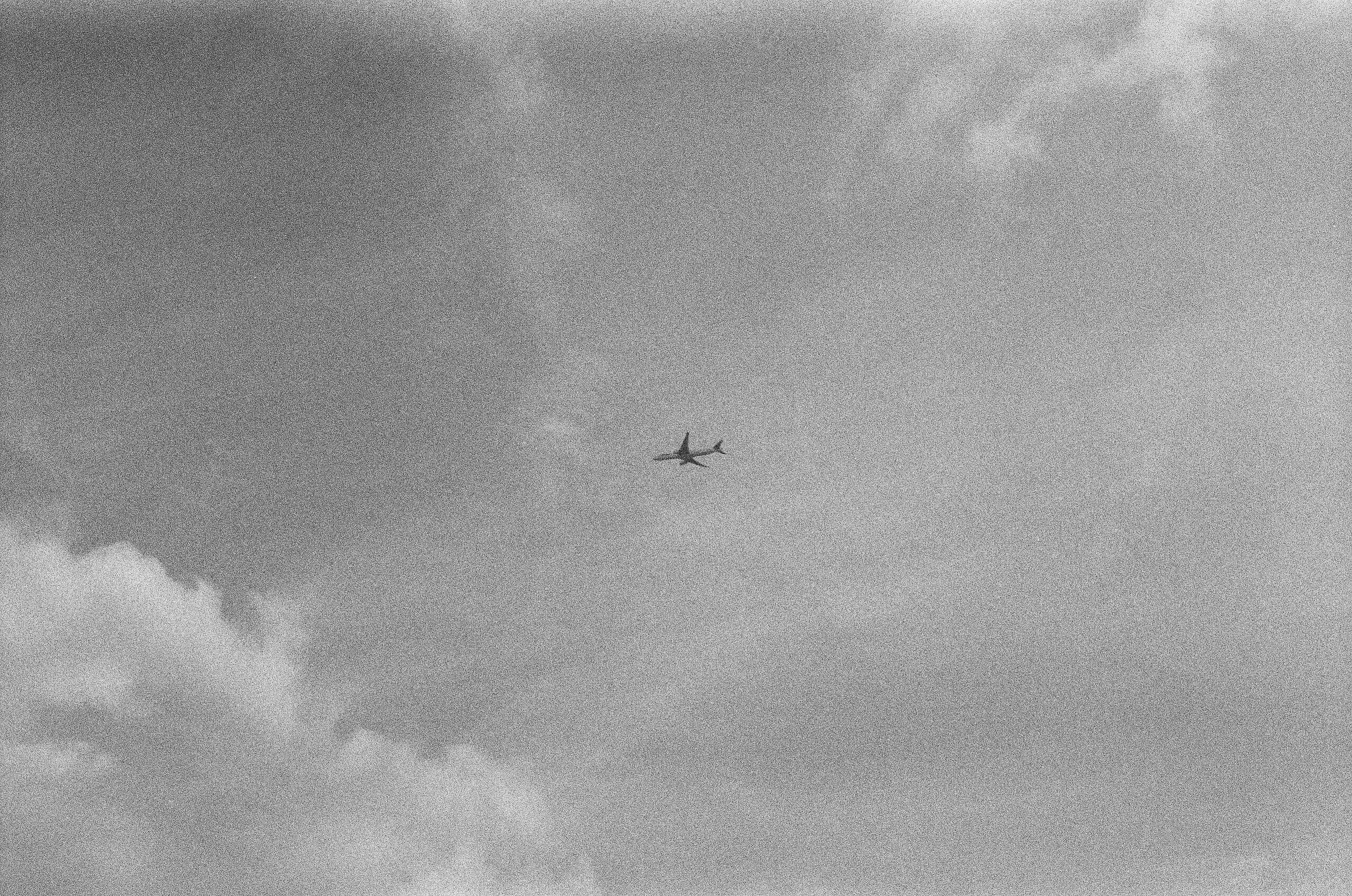 A black and white photo of an airplane in the sky photo – Free ...