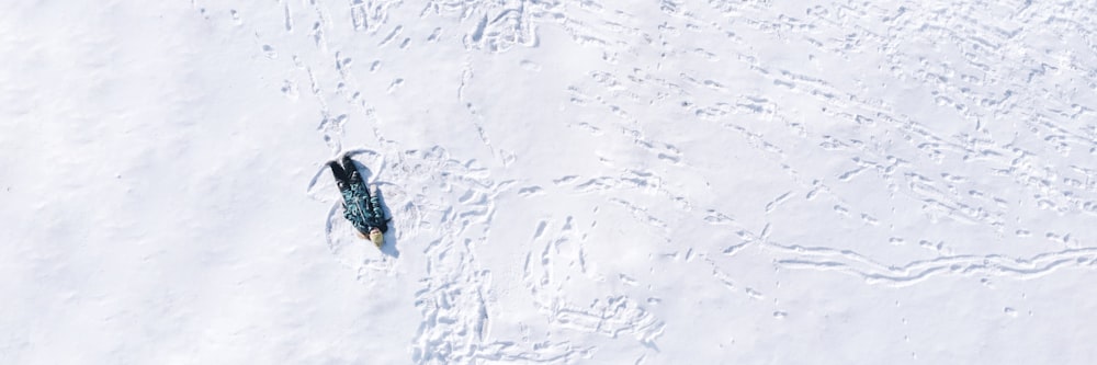 an aerial view of a snowboarder in the snow