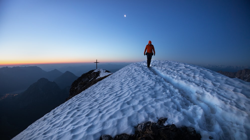 a man standing on top of a snow covered mountain