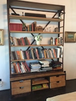 An industrial-style bookshelf filled with books and decorative items.