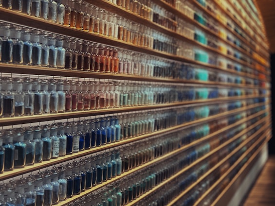 A clean, organized workspace with shelves stocked with various chemical containers and metal powder samples.