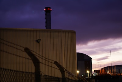 A large industrial generator powered on, set against a dark evening sky