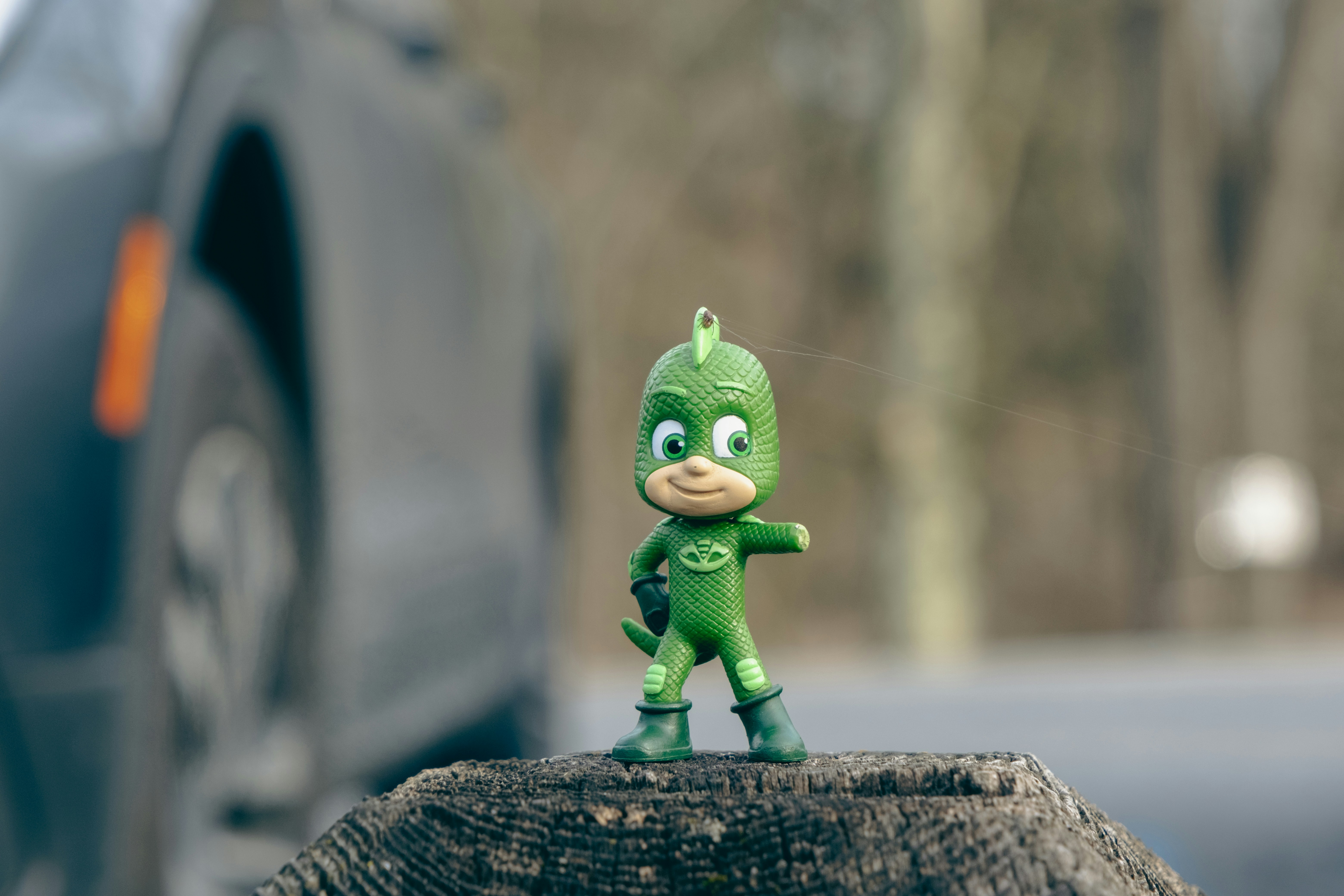 a toy figure is standing on a piece of wood