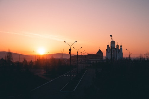 A peaceful sunset view of the synagogue building, glowing softly in the evening light.