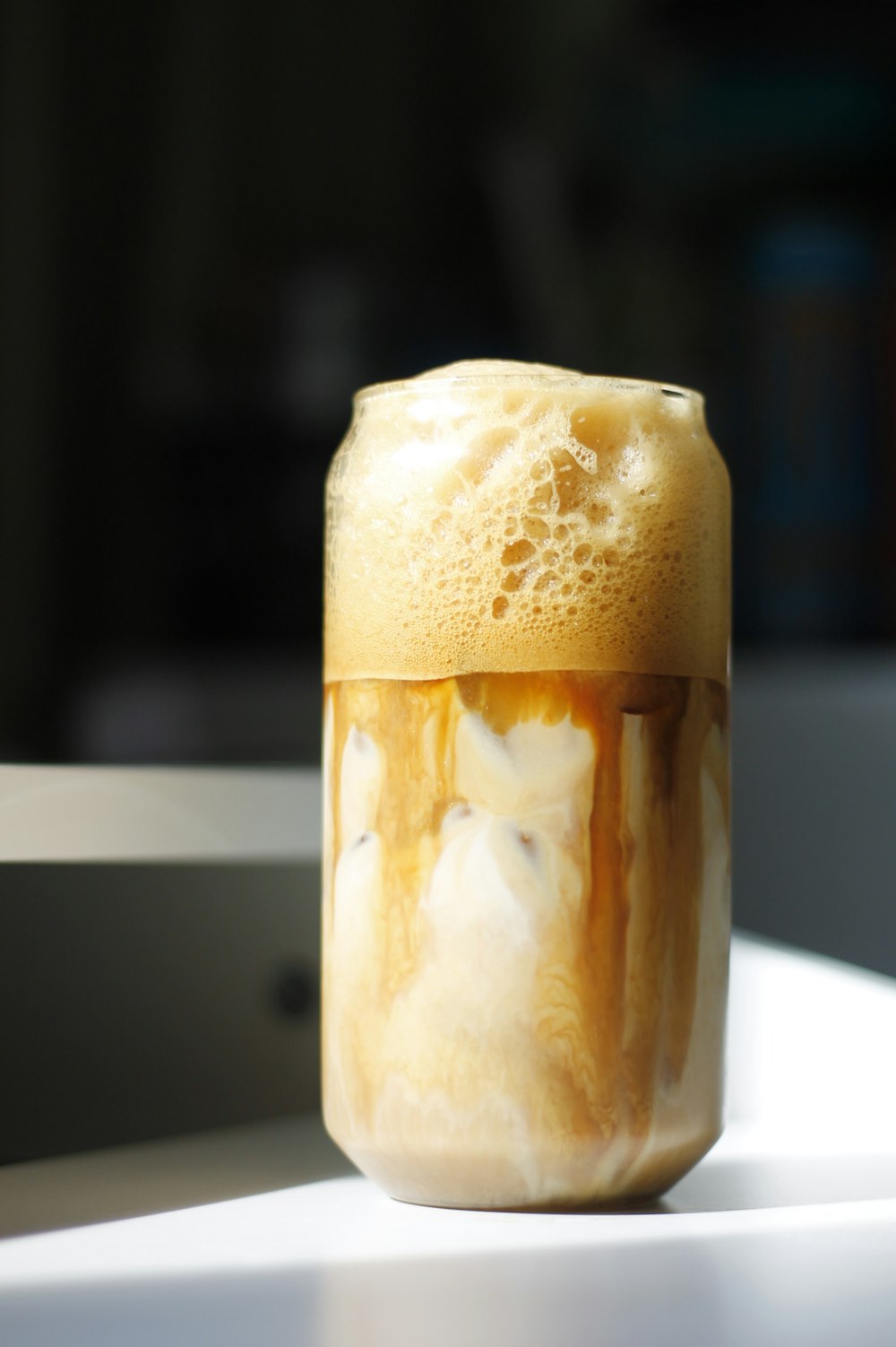 a glass filled with liquid sitting on top of a table