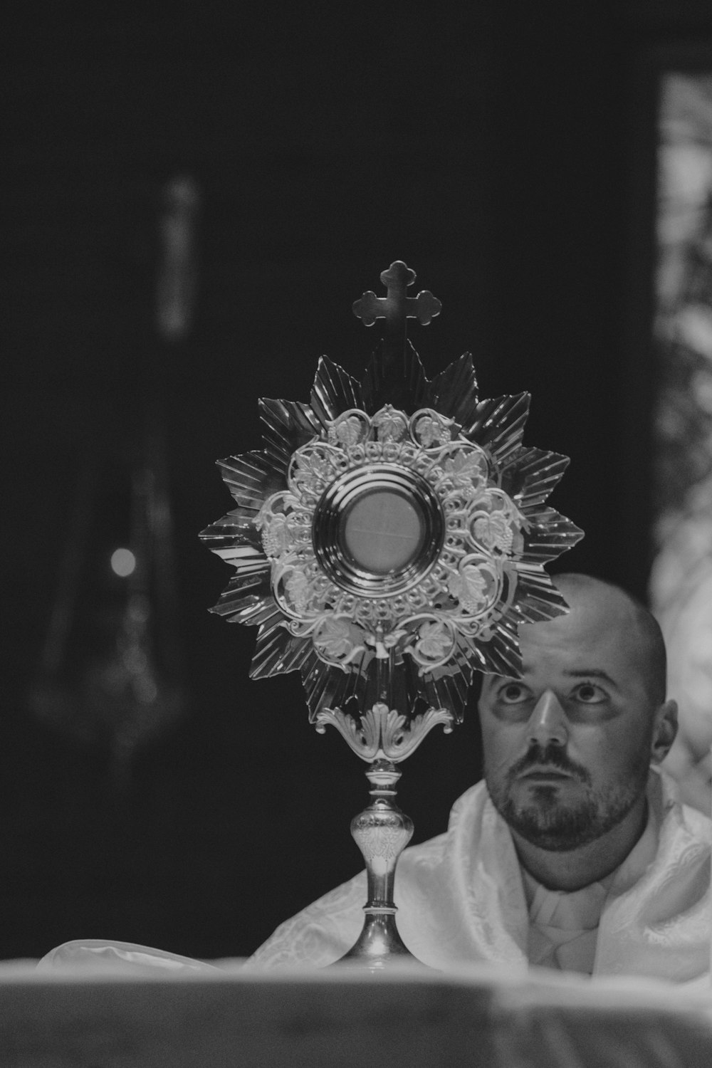 a black and white photo of a priest