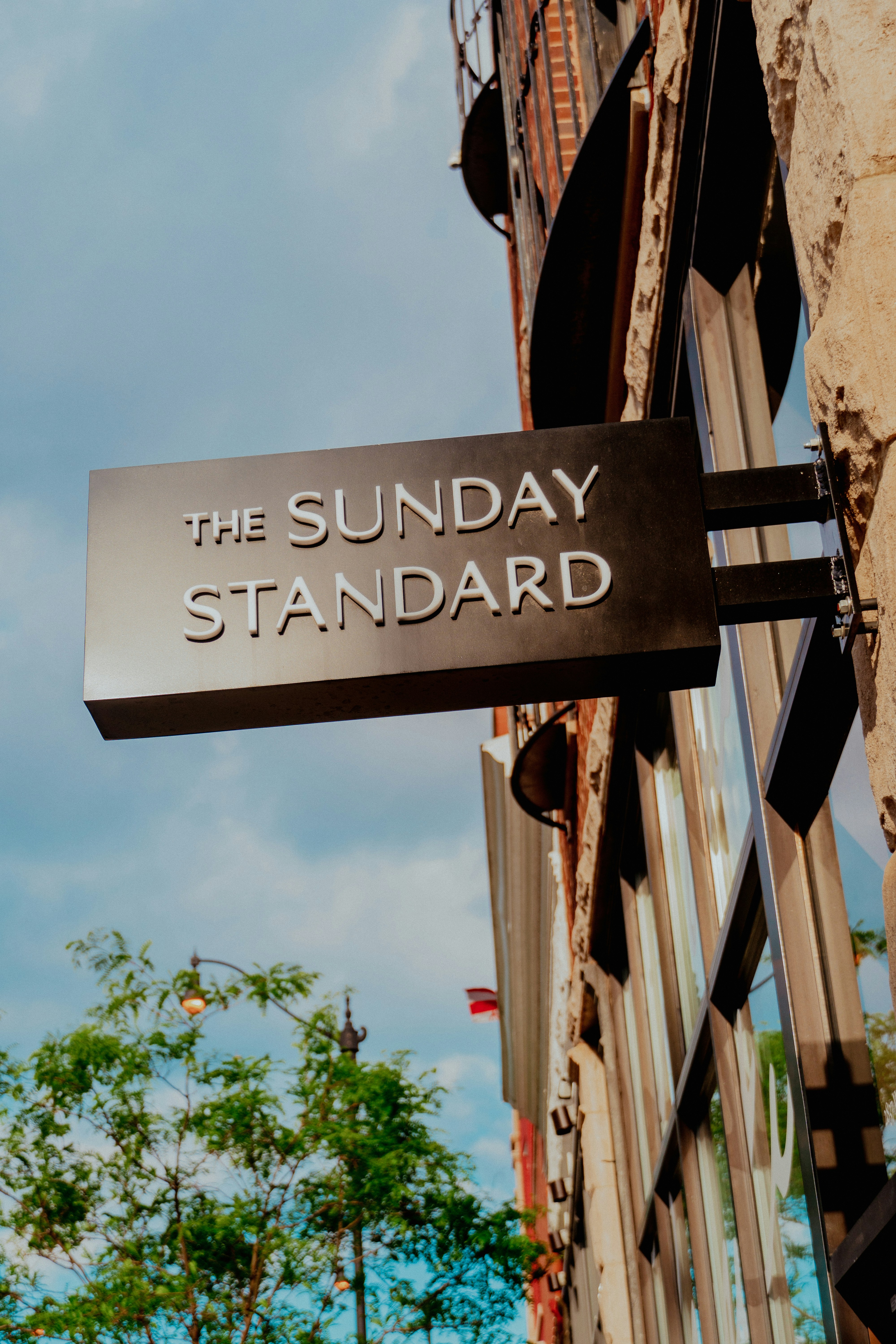 a black and white sign hanging from the side of a building