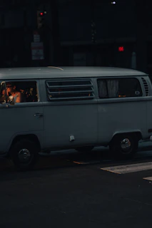 Evening shot of the white Mercedes Vito with its interior lights on, highlighting the workspace inside.