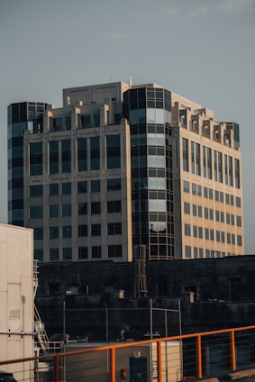 Modern office building with solar panels and industrial equipment visible, representing hypertck's diverse services.