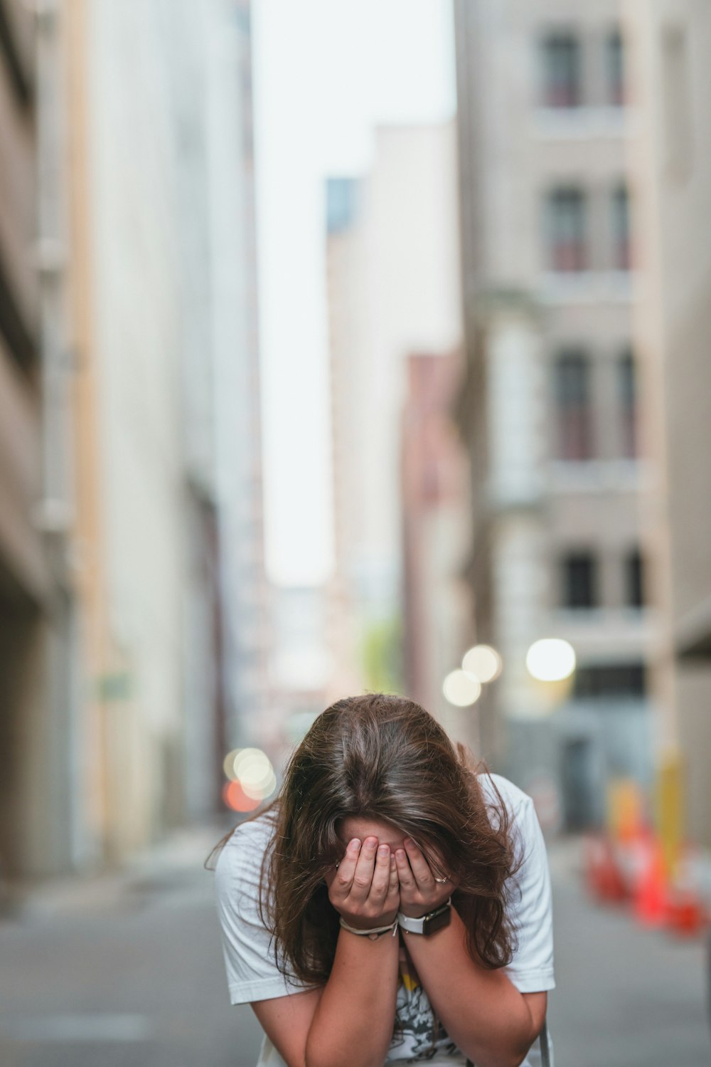 a woman covering her face with her hands