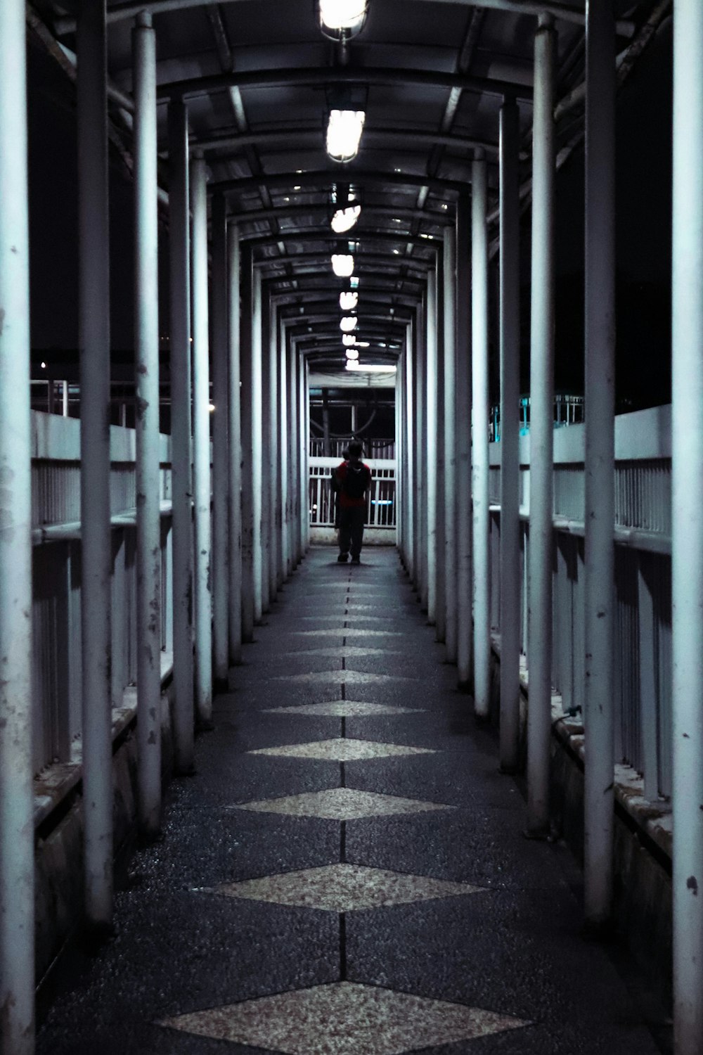 a person is walking down a long walkway