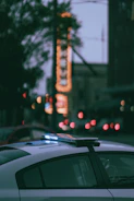 Honolulu cityscape with a police car in the foreground at dusk