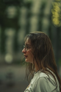 A professional headshot of Libby Kelly Dill with a soft silver gradient backdrop and rounded corners.