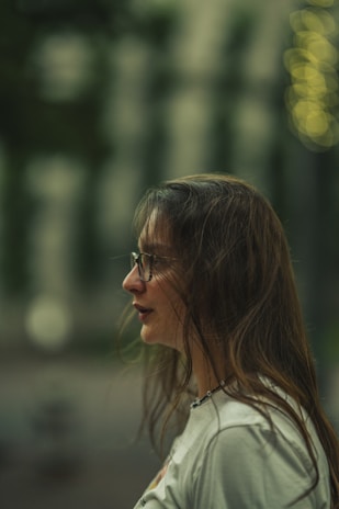 A professional headshot of Libby Kelly Dill with a soft silver gradient backdrop and rounded corners.