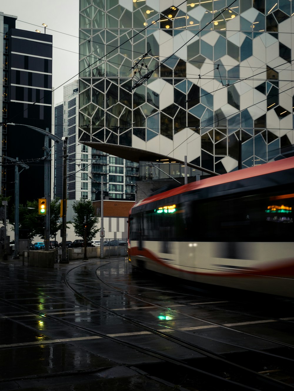 a train on a track in front of a building