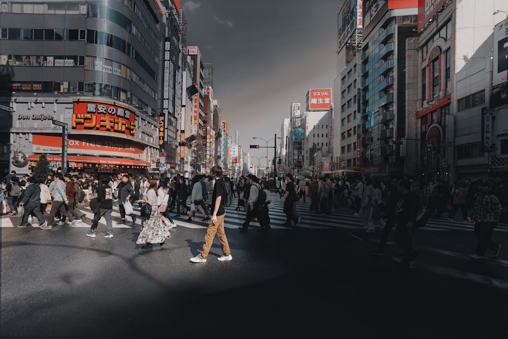 a group of people walking across a street