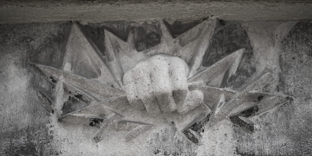 a black and white photo of a hand holding something