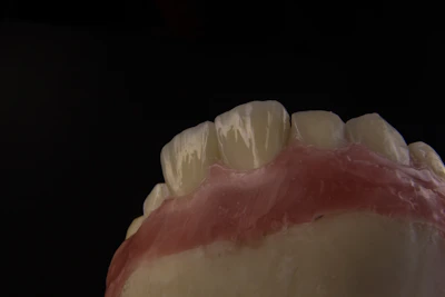 Close-up of a zirconia dental crown being carefully crafted in a modern dental laboratory.