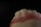 A close-up view of a dental model showing the upper front teeth and gum area, with a dark background emphasizing the detail and texture of the artificial teeth and gums.