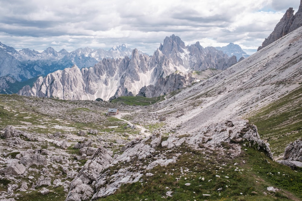 a view of a mountain range with a house in the distance