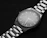 Close-up of a sleek, minimalist watch on a wrist, highlighting its elegant design.