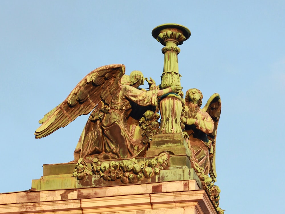 a statue of an angel on top of a building