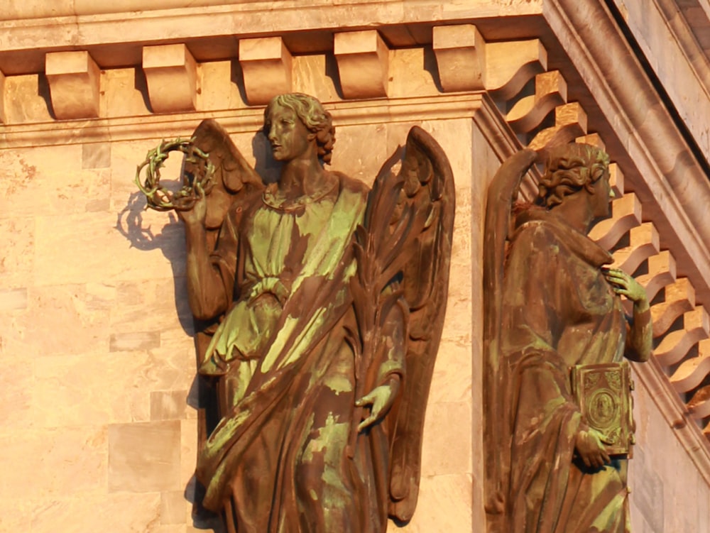 a close up of a statue of an angel on a building