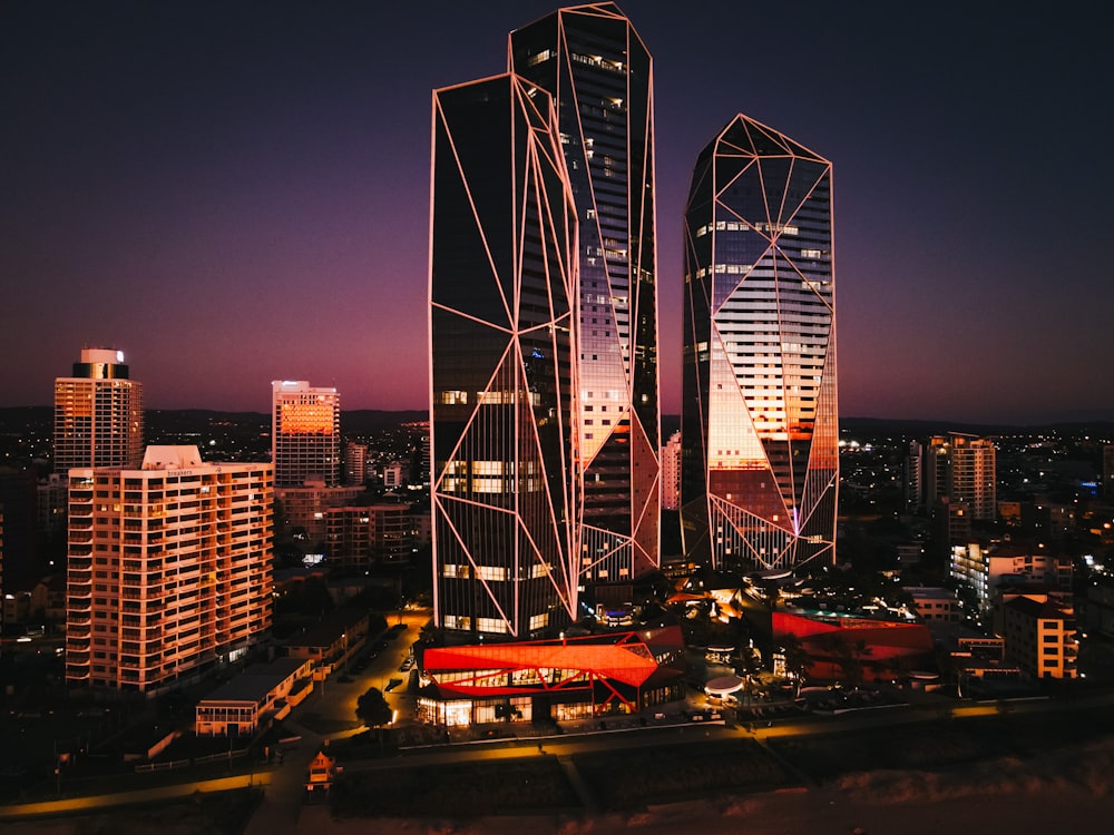 a city at night with tall buildings lit up