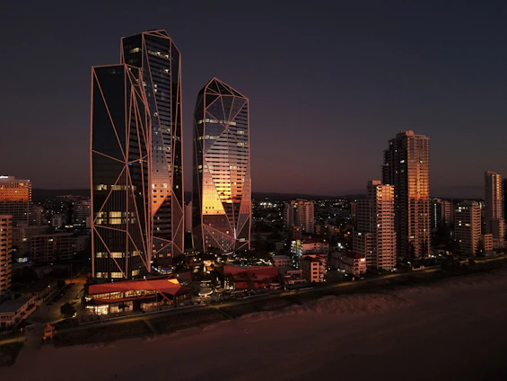 A sleek Manila skyline at dusk blending into a serene luxury beach villa, symbolizing the balance of business and leisure.