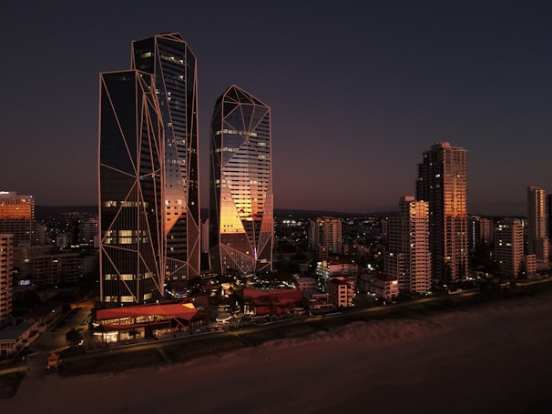 A sleek, modern Dubai skyline at dusk with golden light reflecting off high-rise buildings.