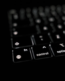 a close up of a black keyboard with white keys