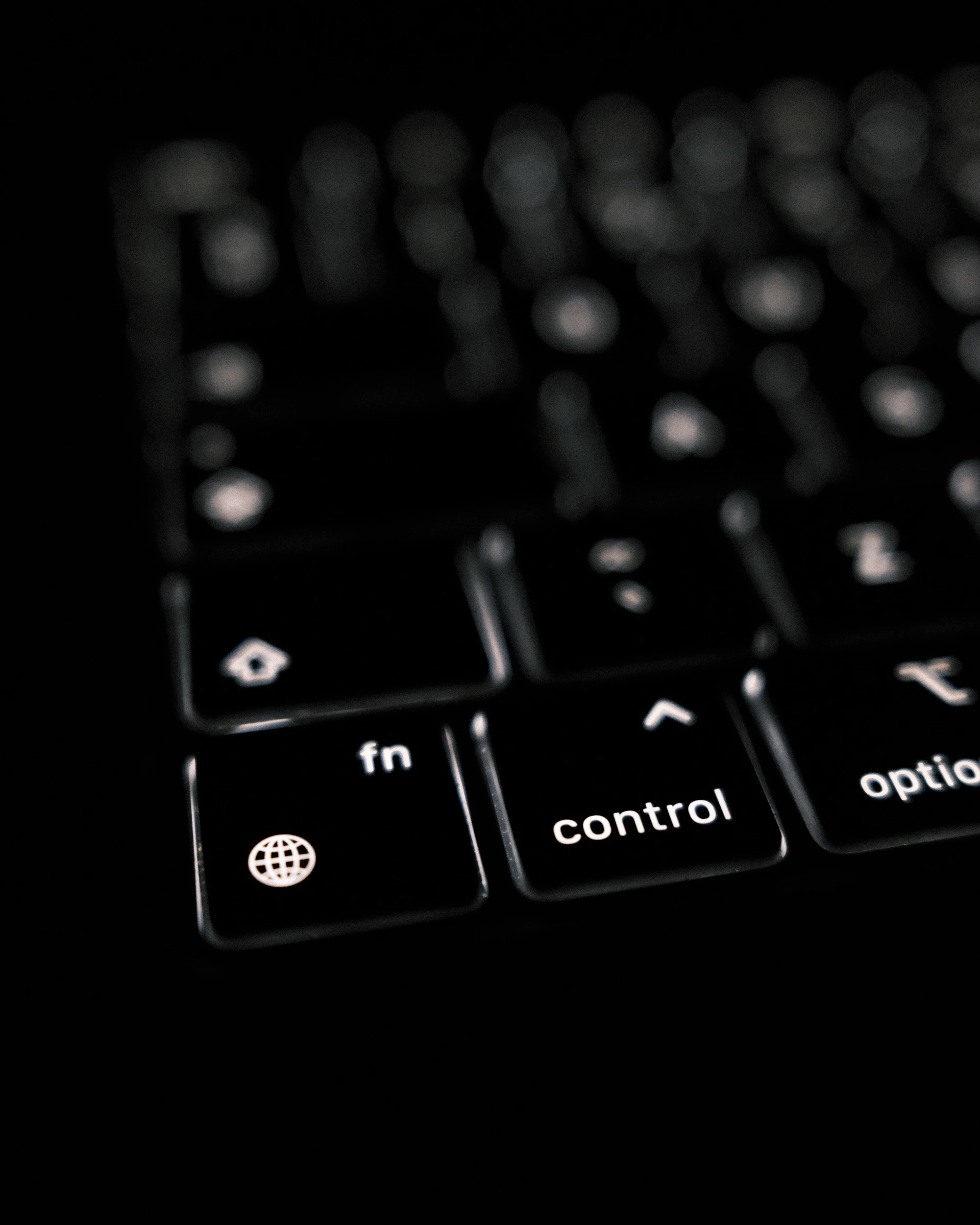 a close up of a black keyboard with white keys