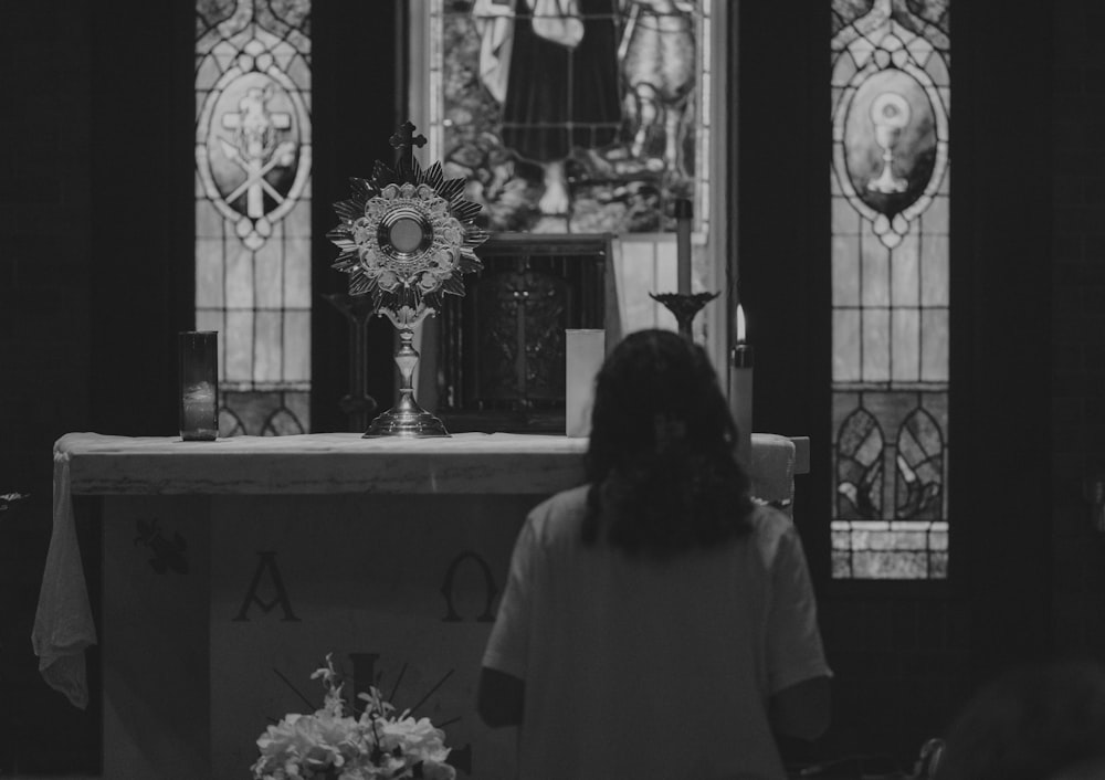 a woman standing in front of a church altar