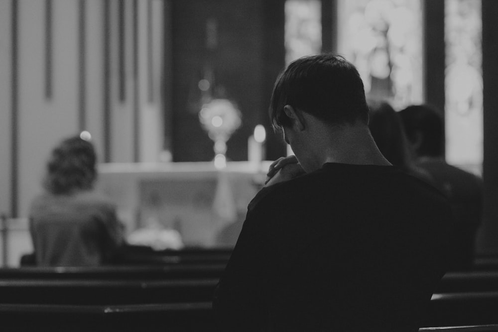 a man sitting in a pew in a church
