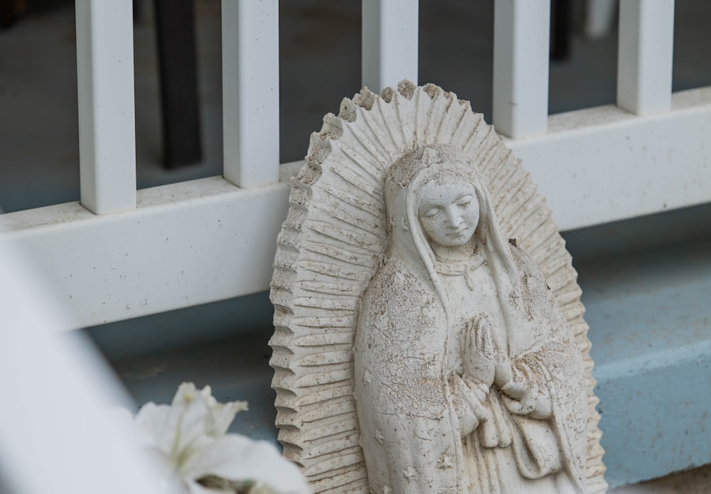 a statue of the virgin mary on a porch