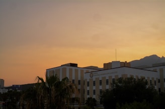 A modern Summerlin condo building with mountain views at sunset.