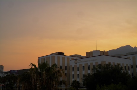 A modern Summerlin condo building with mountain views at sunset.