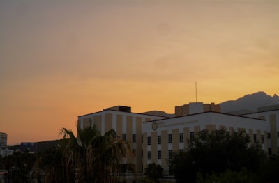 Sunset view of a modern building project in progress, highlighting innovative design and craftsmanship.