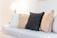 A cozy living room featuring a stylish sofa and decorative pillows.