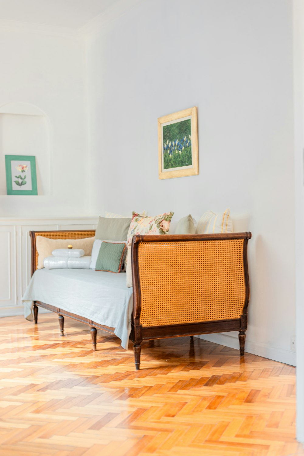 a bed sitting on top of a hard wood floor